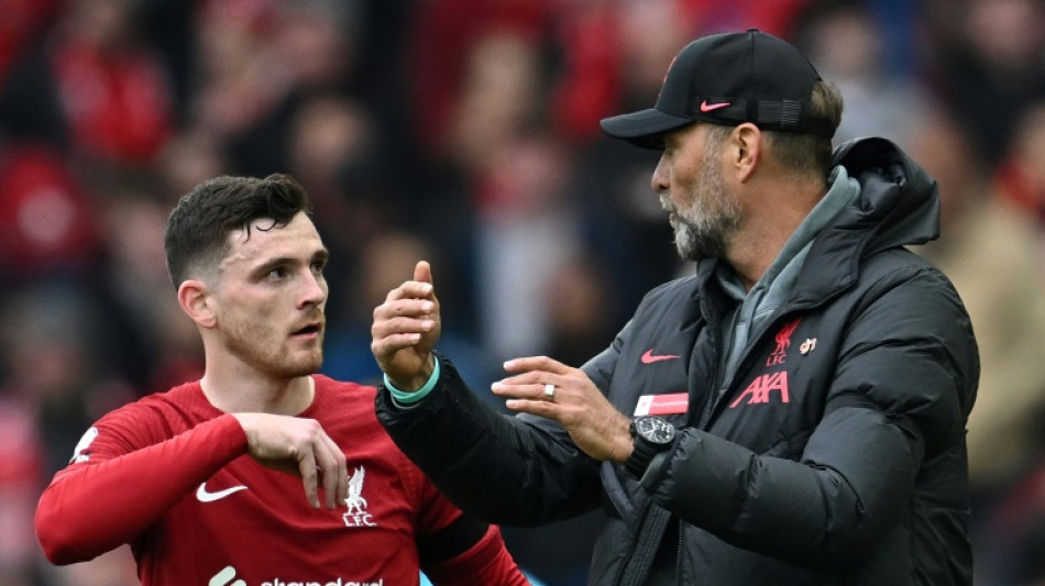 Liverpool's Robertson elbowed by assistant referee